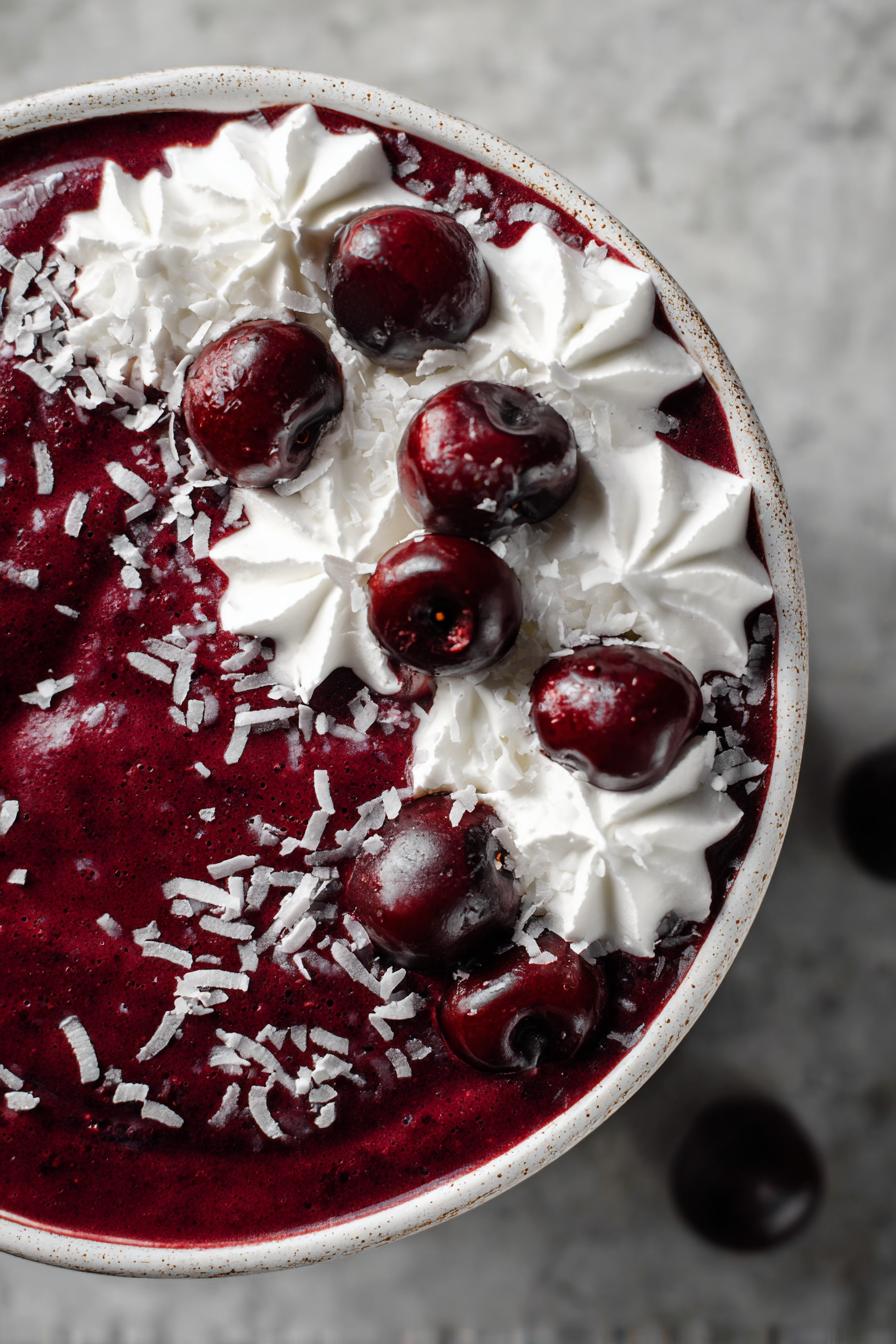 chocolate cherry smoothie bowl with coconut whipped cream